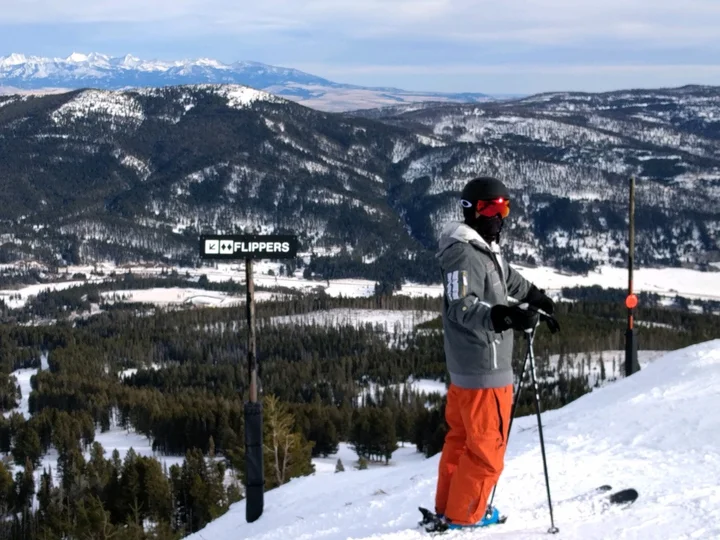 Skiing above a snowy mountain valley